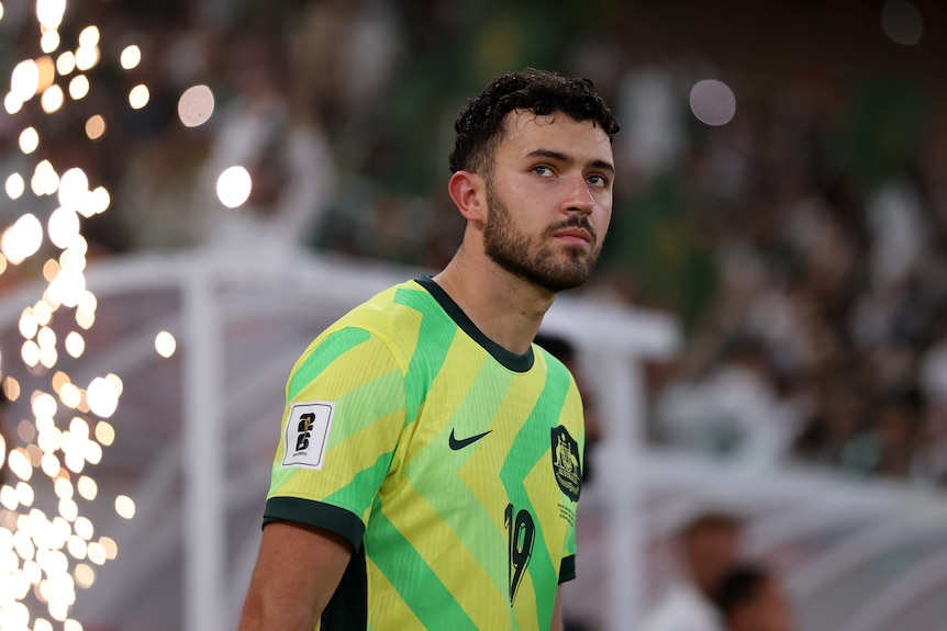 Socceroos player Patrick Yazbek with a serious expression as he enters the pitch