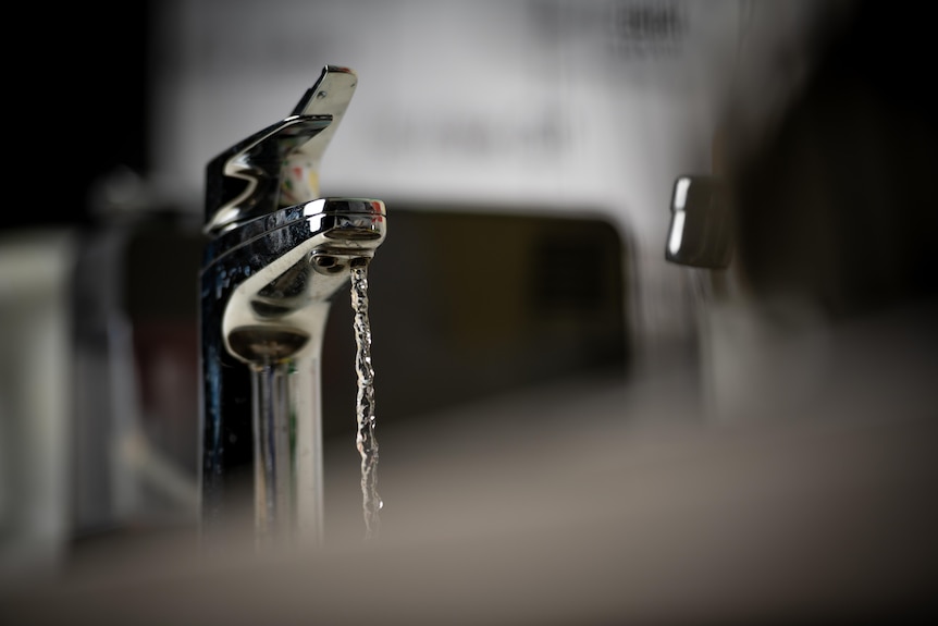 Water flows from a tap.