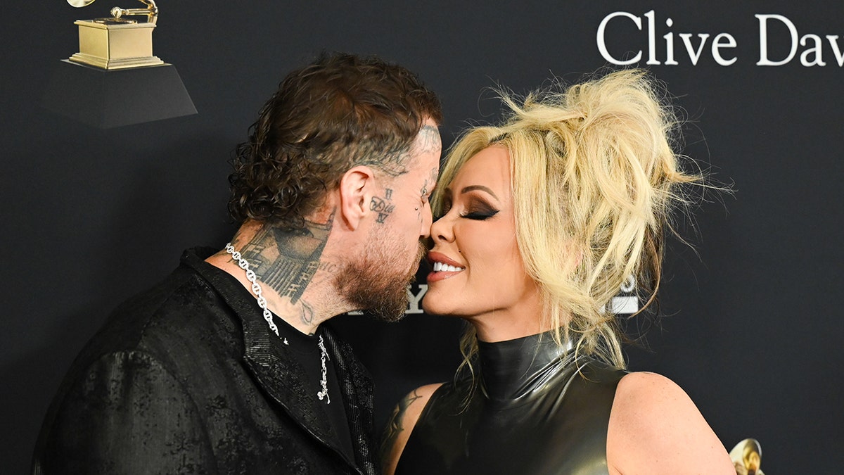 Jelly Roll leans in for a kiss from his wife Bunnie Xo.