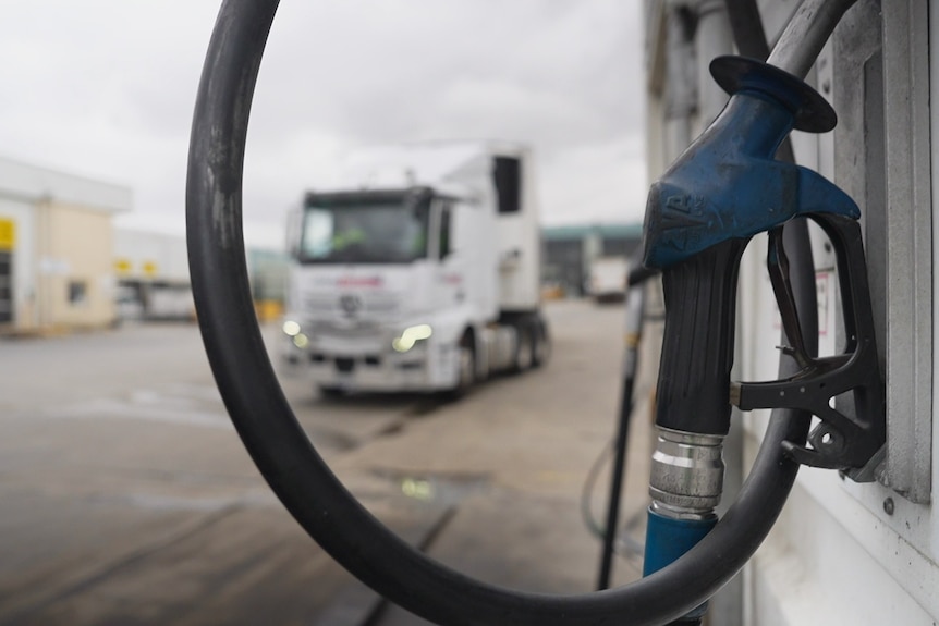 Fuel bowser with a big truck in the background.