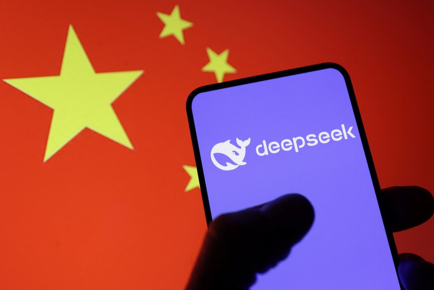 A dark silhouette of a hand holding a mobile phone showing a purple DeepSeek logo and loading screen in front of a Chinese flag
