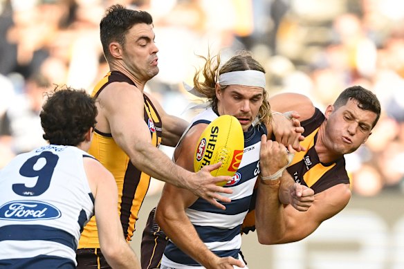 Bailey Smith in the thick of the action against Conor Nash and Lloyd Meek during last year’s Easter Monday clash between Hawthorn and Geelong.