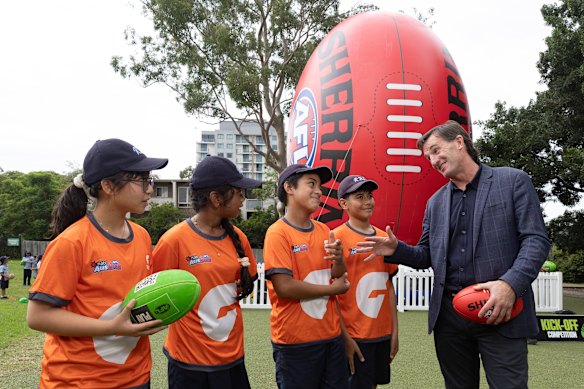 AFL CEO Andrew Dillon
speaks to school children as he poses with students from Rosehill Public School during an AFL School Connect visit to Rosehill Public School.