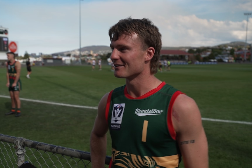 A young man in a football jersey.