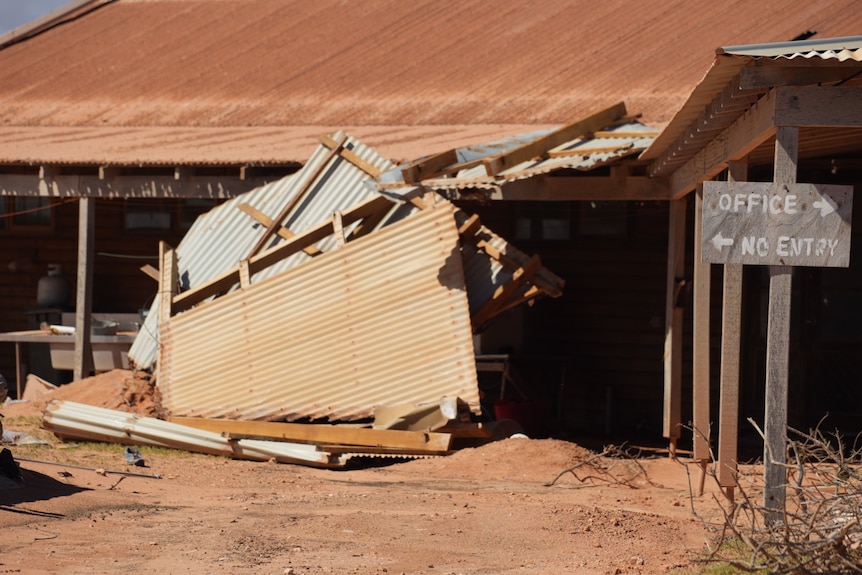 Part of tin roof fallen off building.