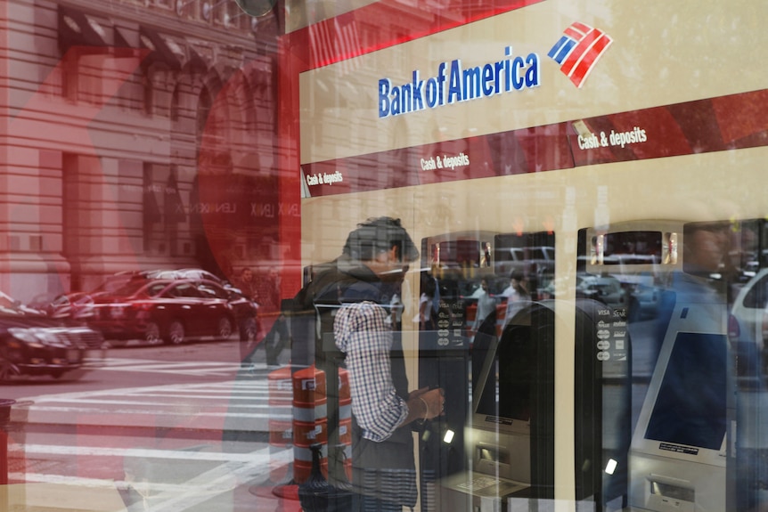 A photo of a customer using an ATM at a Bank of America branch in Boston.