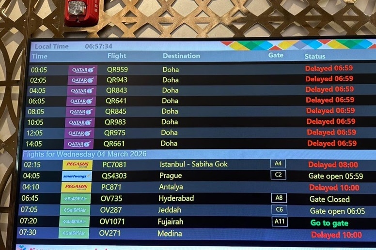 A departure and arrival board at Doha airport full of delayed flights 