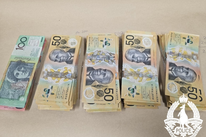 Stacks of $100 and $50 notes.