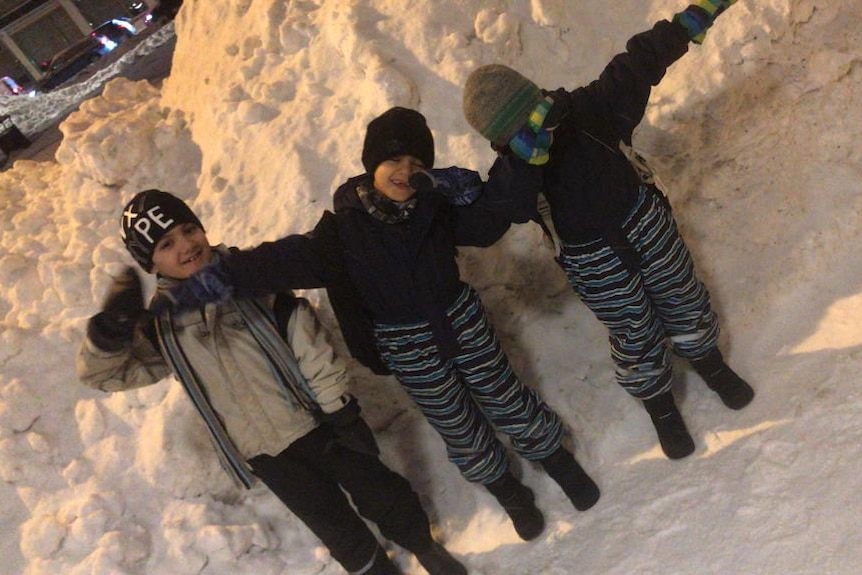 Ghanim's children in Finland in the snow.