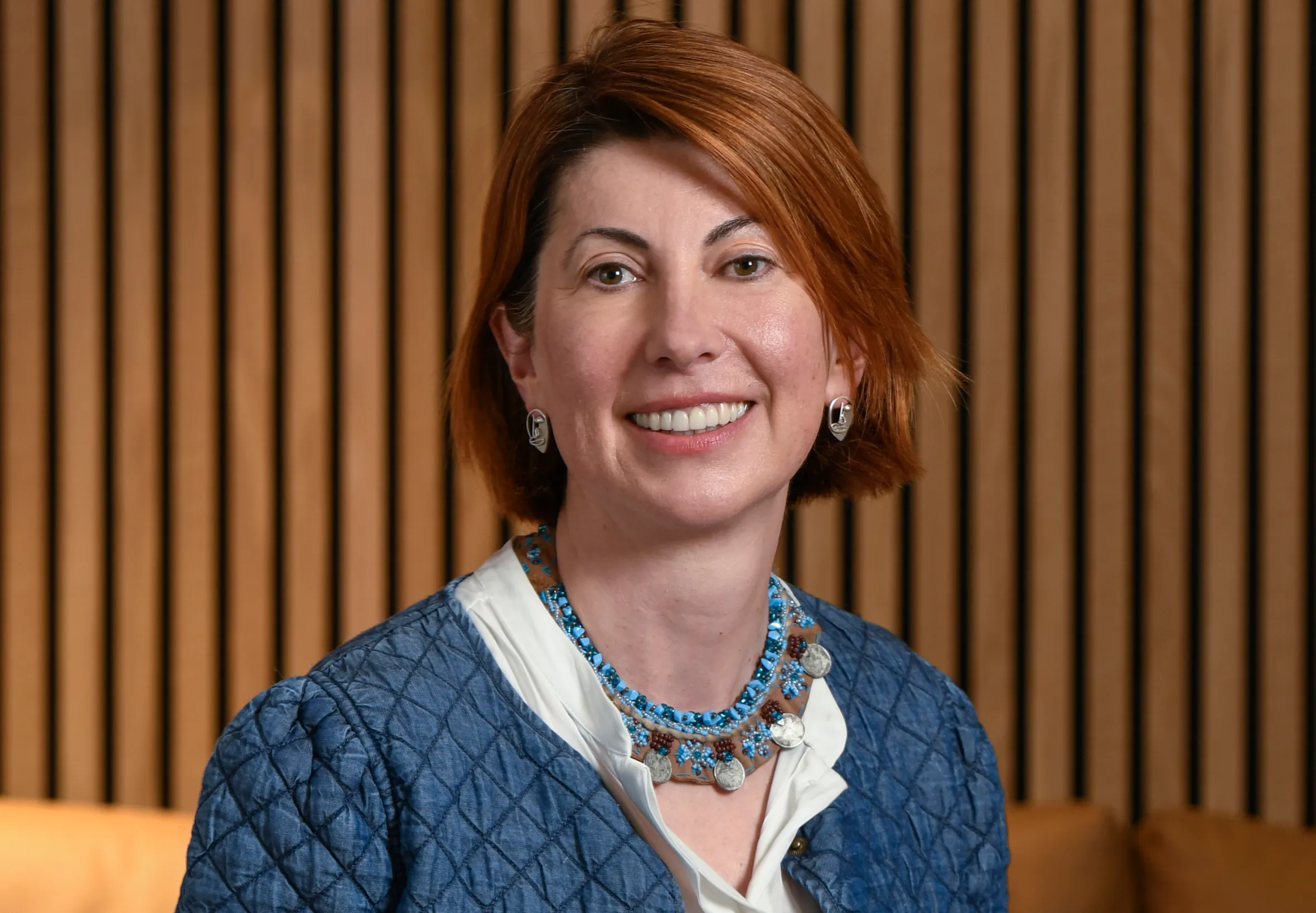 Mihriban Tuna seated, smiling.