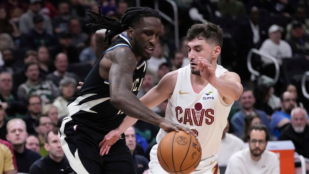 Cleveland Cavaliers' Ty Jerome knocks the ball from Milwaukee Bucks' Taurean Prince during the first half of an NBA basketball game Sunday, Mar. 9, 2025, in Milwaukee. (AP Photo/Morry Gash)