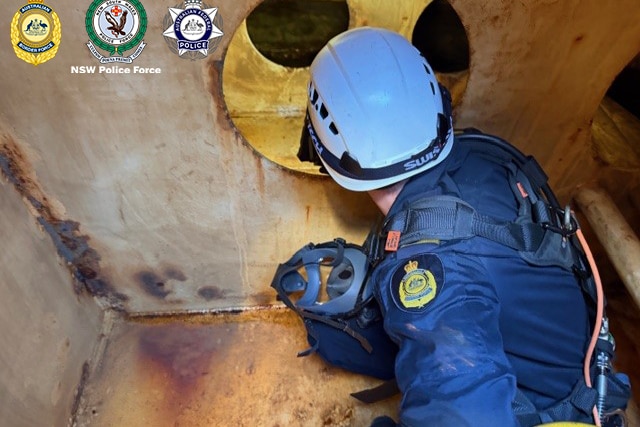 A police officer looking through a tunnel