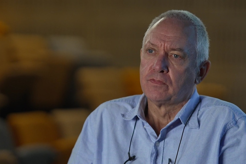Older man wearing a blue shirt.