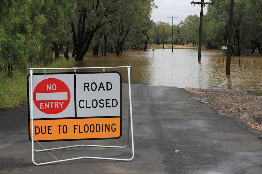 road closed sign at flooded road