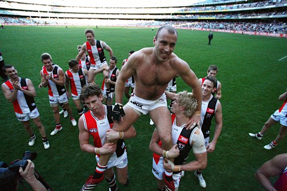 Andrew Thompson and Fraser Gehrig chaired off the ground by Saints teammates in 2007.