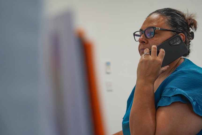 A woman speaks on a mobile phone.
