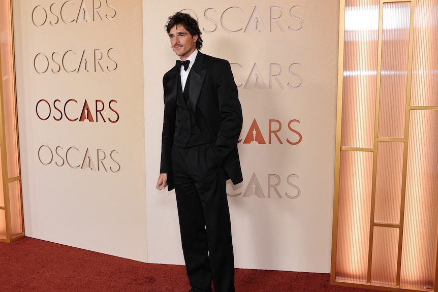 Jacob Elordi in a black suit.