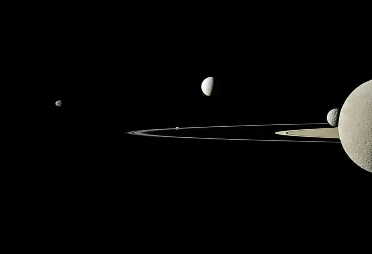 An image showing several moons orbiting Saturn.