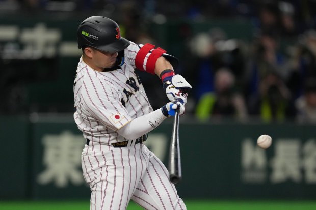 Japan's Seiya Suzuki hits a home run during the third inning of a World Baseball Classic game between Japan and South Korea on Saturday, March 7, 2026 in Tokyo, Japan. (AP Photo/Hiro Komae)