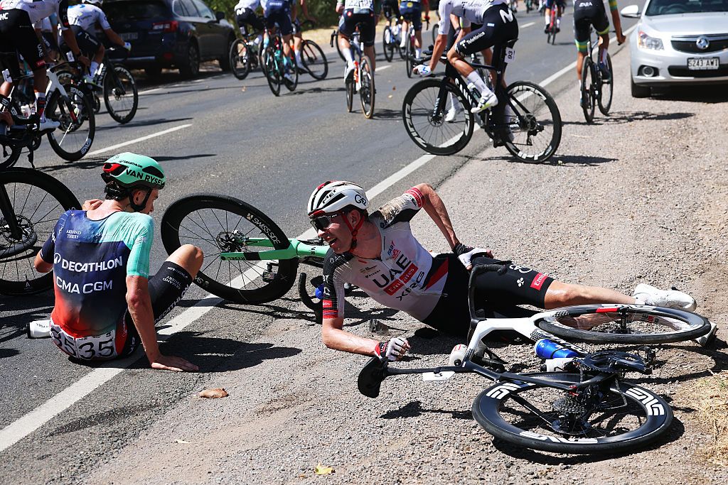 WILLUNGA, AUSTRALIA - JANUARY 24: (L-R) Antoine L&amp;apos;Hote of France and Decathlon CMA CGM Team and Vegard Stake Laengen of Norway and UAE Team Emirates crash during the 26th Santos Tour Down Under 2026, Stage 4 a 130.8km stage from Brighton to Willunga / #UCIWT / on January 24, 2026 in Willunga, Australia. (Photo by Con Chronis/Getty Images)