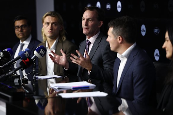AFL CEO Andrew Dillon announces the new illicit drugs policy alongside Bulldogs CEO Ameet Bains, Collingwood captain Darcy Moore, AFLPA boss James Gallagher and football operations boss Laura Kane.