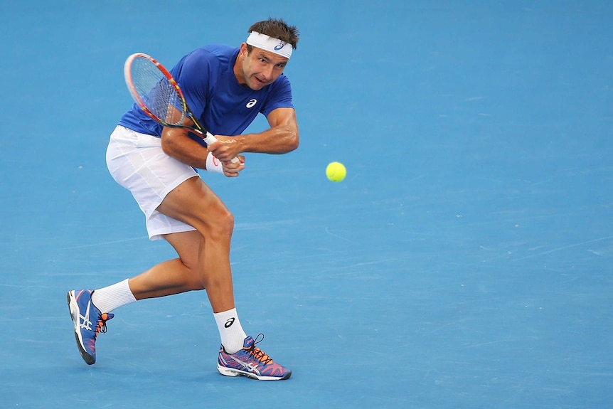 Marinko Matosevic backhands during Brisbane International loss