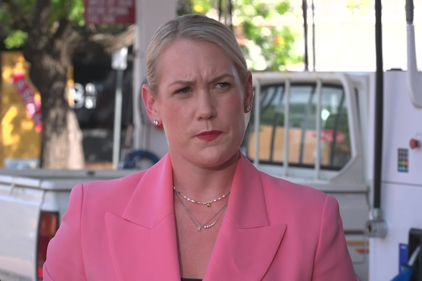 Ashton Hurn frowns at a service station where a ute is filling up