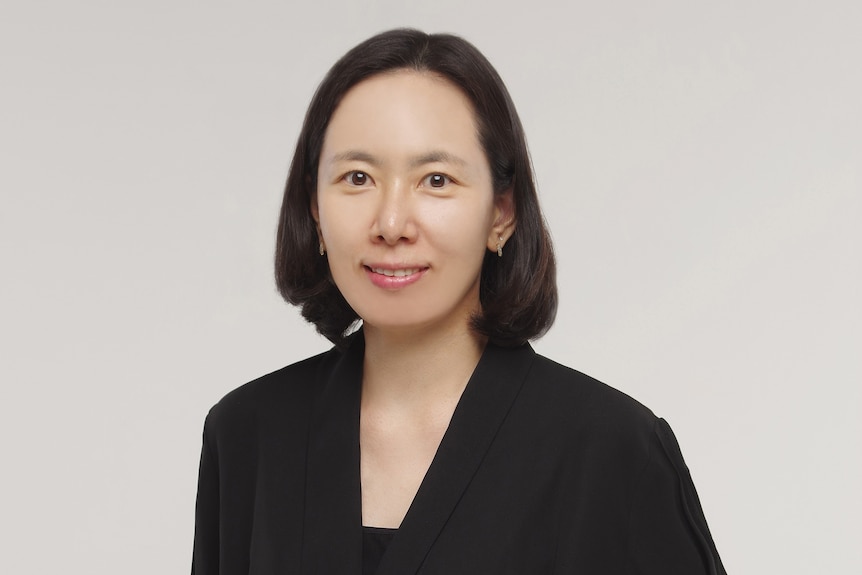 A woman with short hair looking at camera.