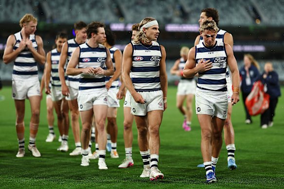 Tanner Bruhn (right) leaves the ground with his teammates aftee their win over the Crows.