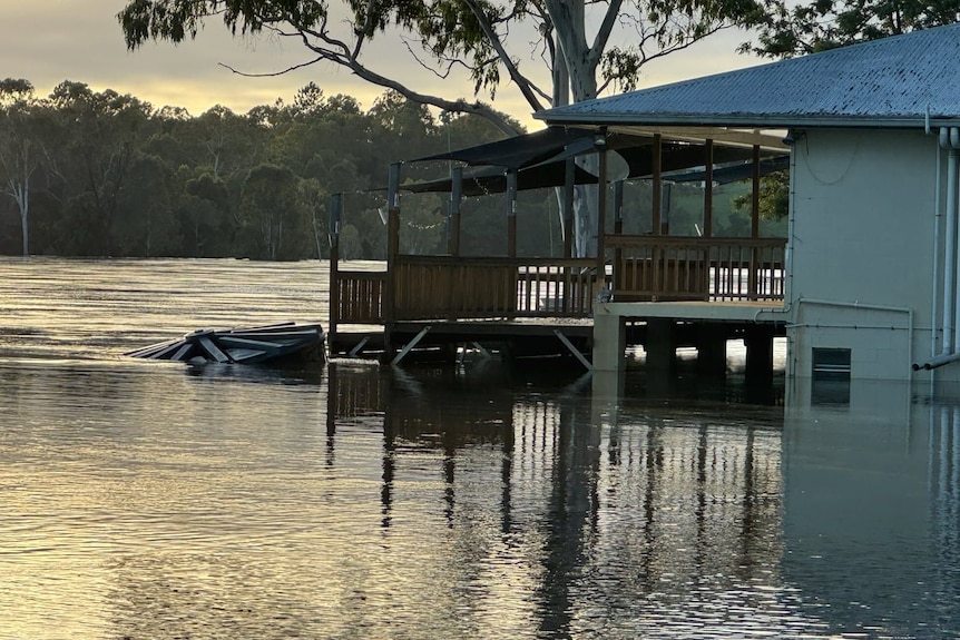 A partially submerged building on a river.