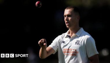 Pace bowler Mitch Perry tosses a ball up in the air as he walks back to his mark.