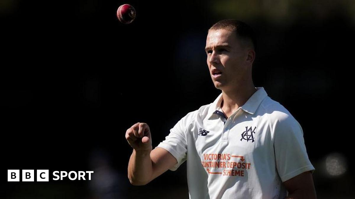 Pace bowler Mitch Perry tosses a ball up in the air as he walks back to his mark.