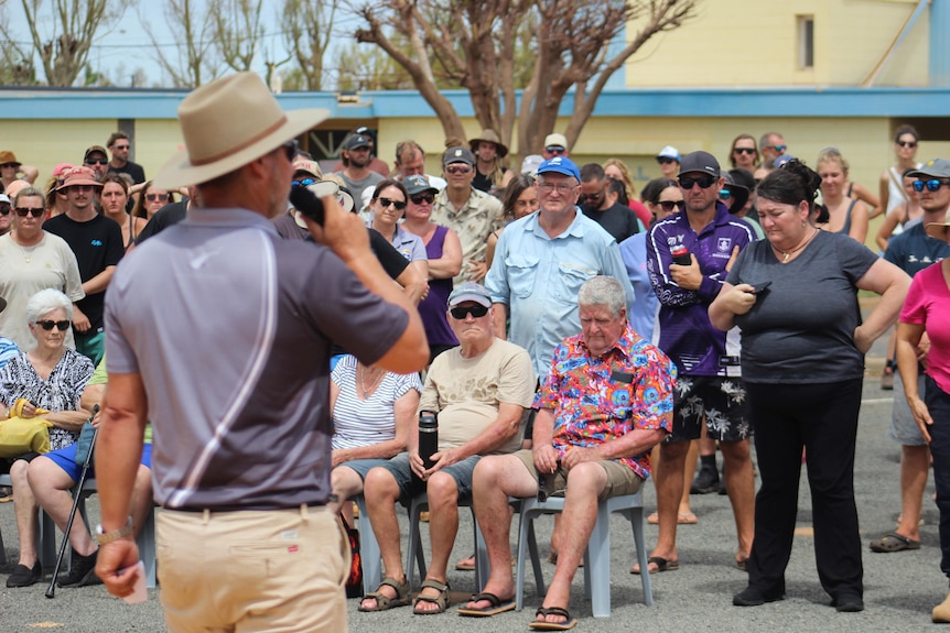 A man is is addressing the crowd at an information meeting after ex-TC Narelle hit. 