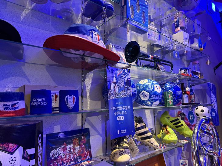 Merchandise from Suwon Samsung Bluewings and signed football boots are displayed at Samgwang, a supporters' pub in Suwon, Gyeonggi Province, Feb. 28. Korea Times photo by Lee Hae-rin