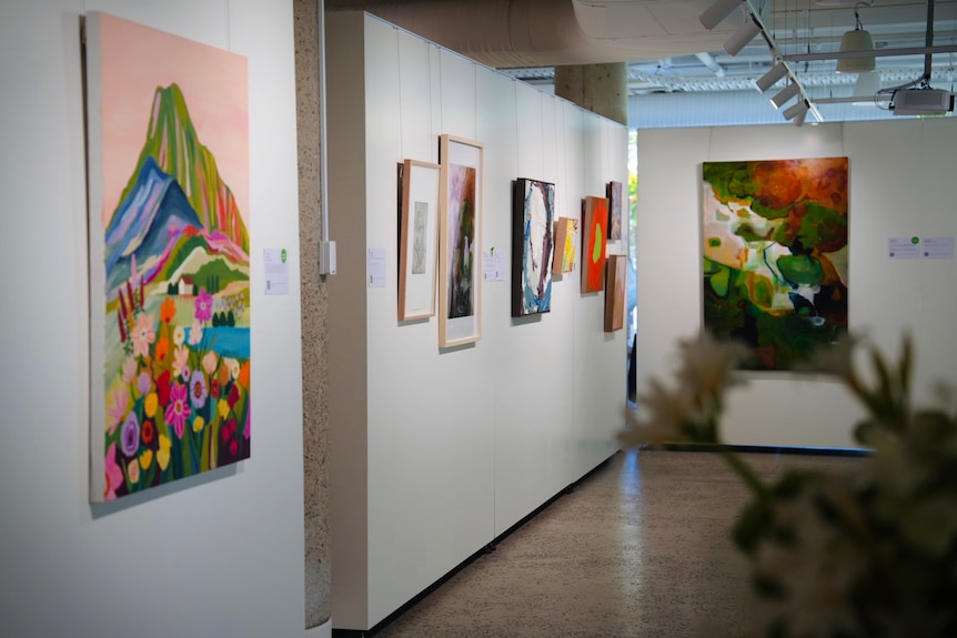 Art galley, white walls, coloured paintings
