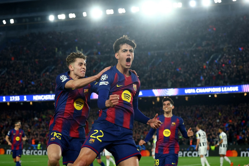 Barcelona's Marc Bernal celebrates scoring a goal, pumping his fist, chased by teammates