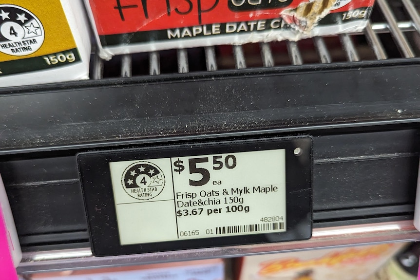 A small screen on a supermarket aisle displays a product name and price.