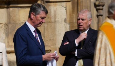 Sir Timothy Laurence, left, husband of Princess Anne, speaks to Prince Andrew as they arrive for the Easter Matins Service at St. George