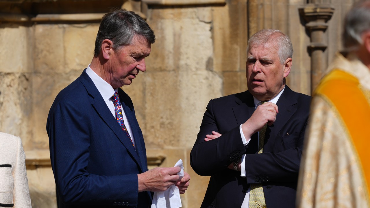 Sir Timothy Laurence, left, husband of Princess Anne, speaks to Prince Andrew as they arrive for the Easter Matins Service at St. George