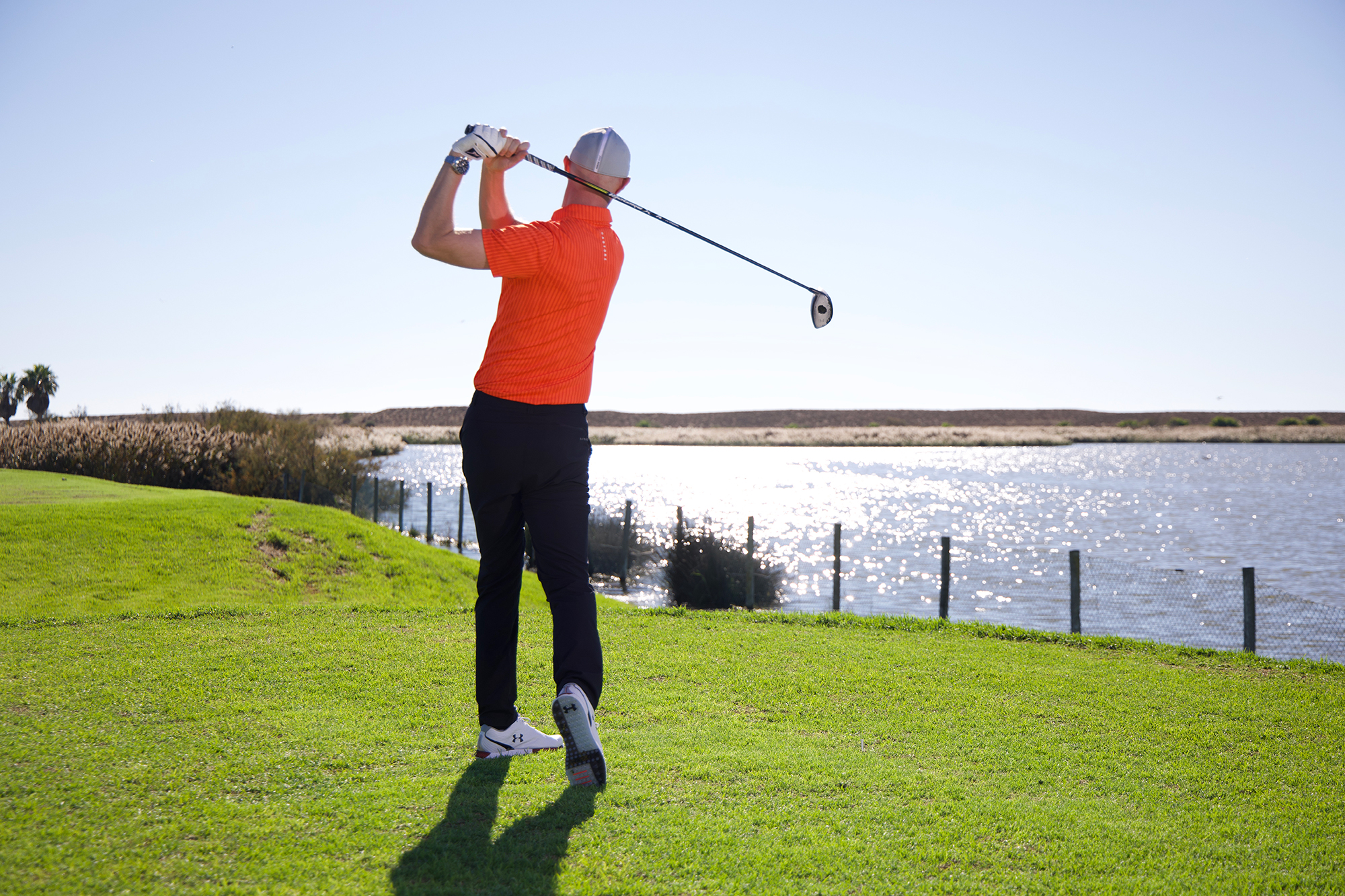 Ged Walters in the finish position with driver, with the clubface of the driver showing a mark in the centre thanks to the dry shampoo drill