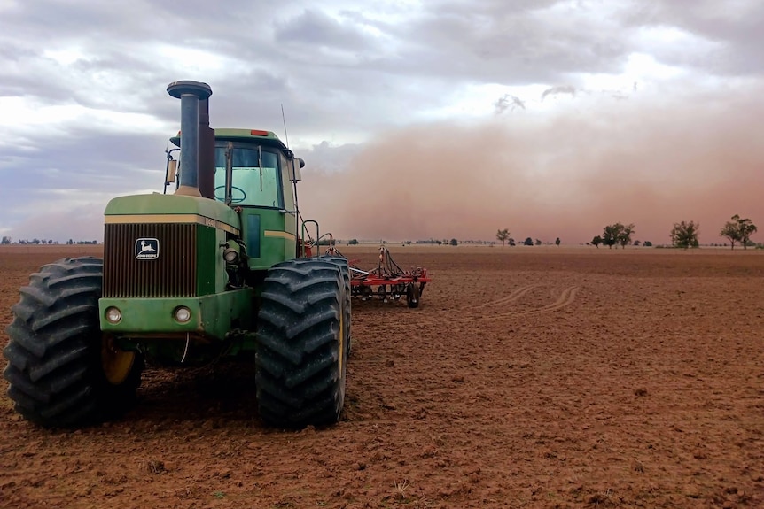 Tractor wiht dust storm behind