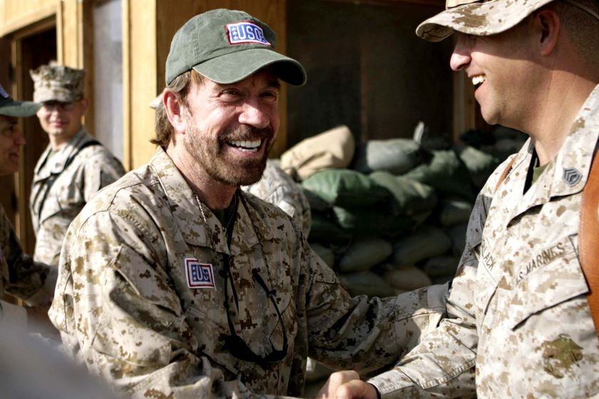Chuck Norris shakes hands with Gunnery Sgt John C Pollack at Camp Taqaddum in Iraq