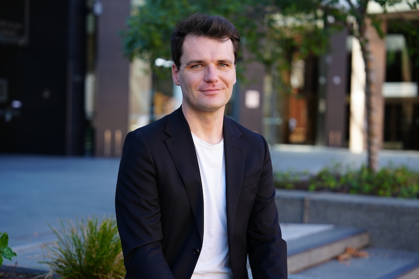 Independent economist Conrad Liveris in a jacket and shirt looking at the camera