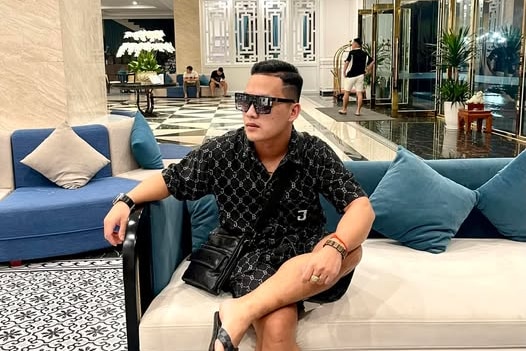 A man sits in a hotel lobby.