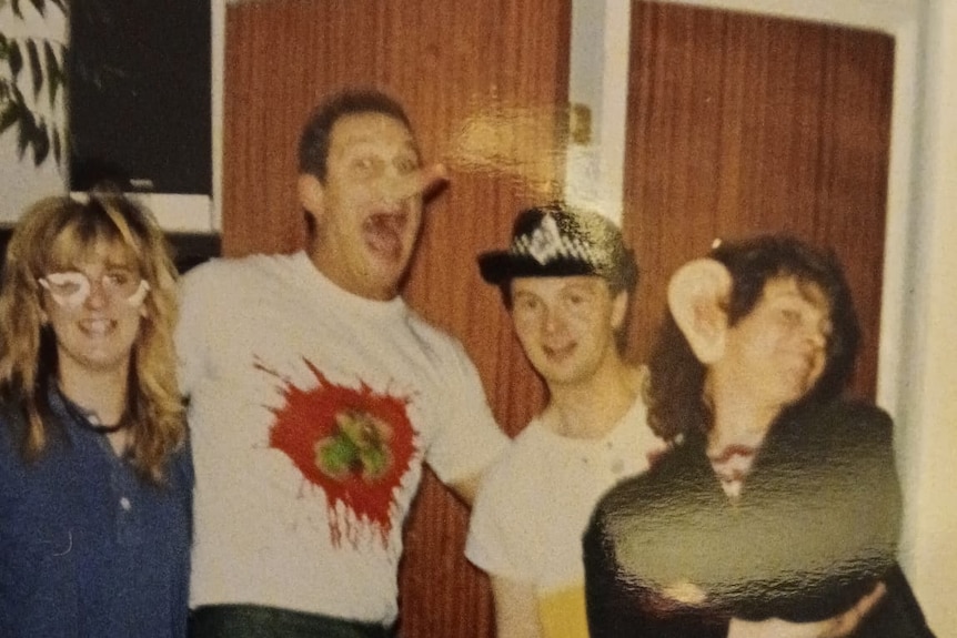 A lady with overalls and a pair of glasses, a man with a pinoccio nose, a man with a police hat and a lady with monkey ears