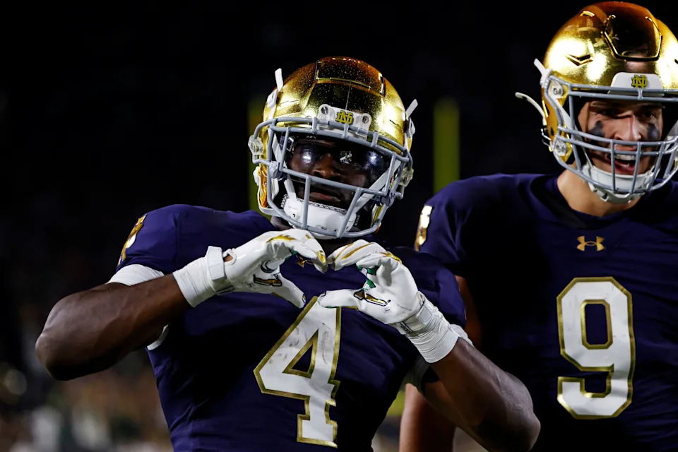 Sep 13, 2025; South Bend, Indiana, USA; Notre Dame Fighting Irish running back Jeremiyah Love (4) shares a heart with the fans during the second half against the Texas A&M Aggies at Notre Dame Stadium. Mandatory Credit: Michael Caterina-Imagn Images