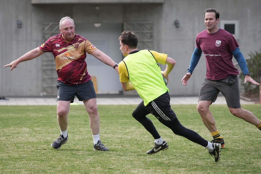 Three men playing touch football.