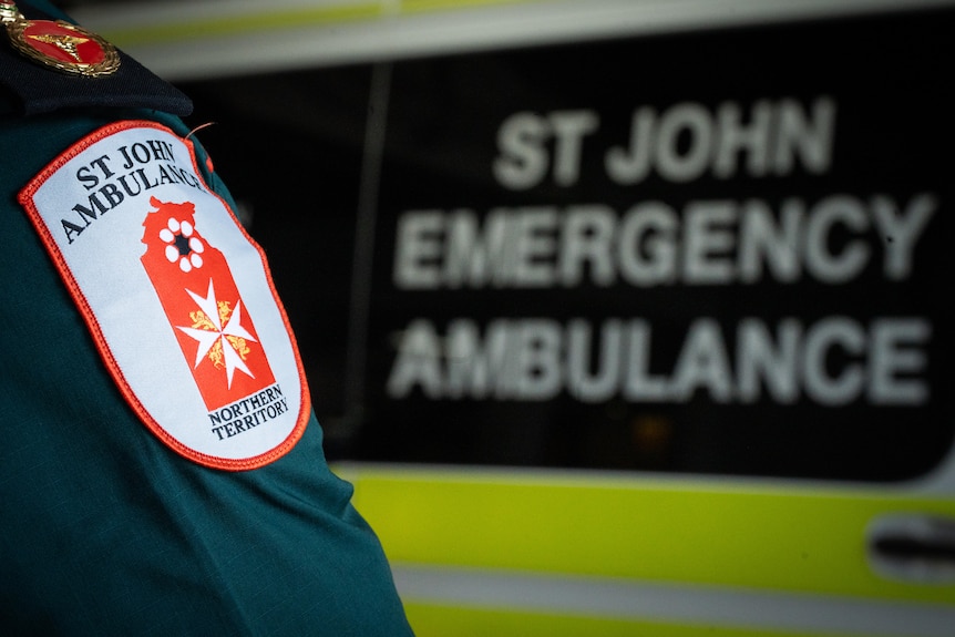 St John NT ambulance paramedic patch in front of ambulance