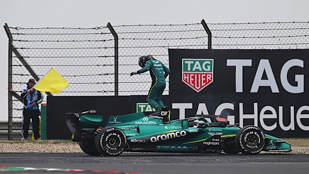 Lance Stroll of Aston Martin F1 Team jumps out of his car.