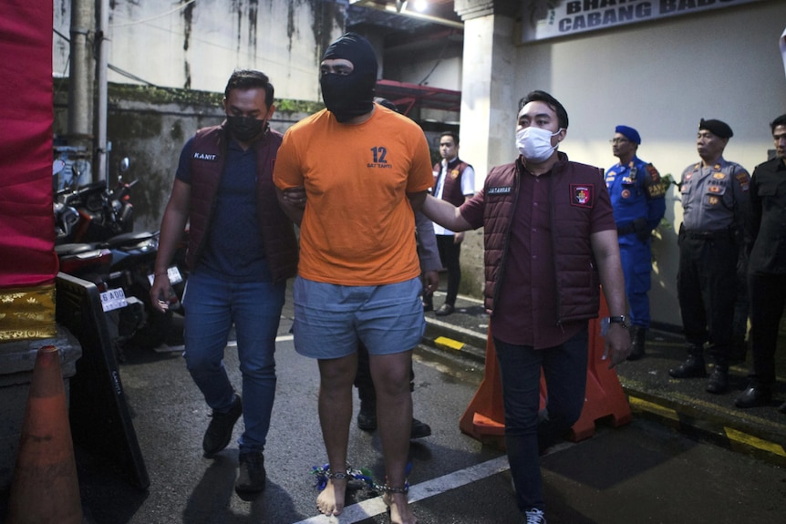 Indonesian police escort an Australian suspect